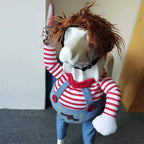 White dog standing in striped shirt and overalls Halloween costume with red wig and foam knife